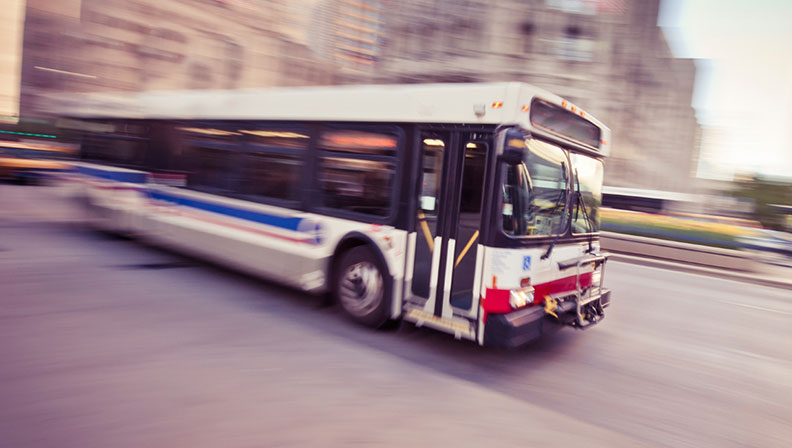 City Bus HVAC driving through a cityscape